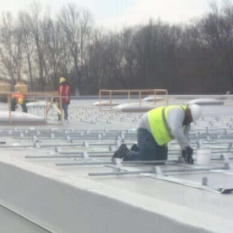 Roof workers installing commercial roofing
